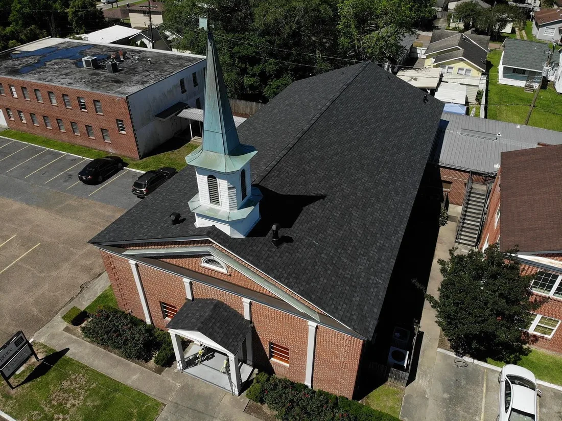 Aerial of a re-roofed brick church with a steeple
